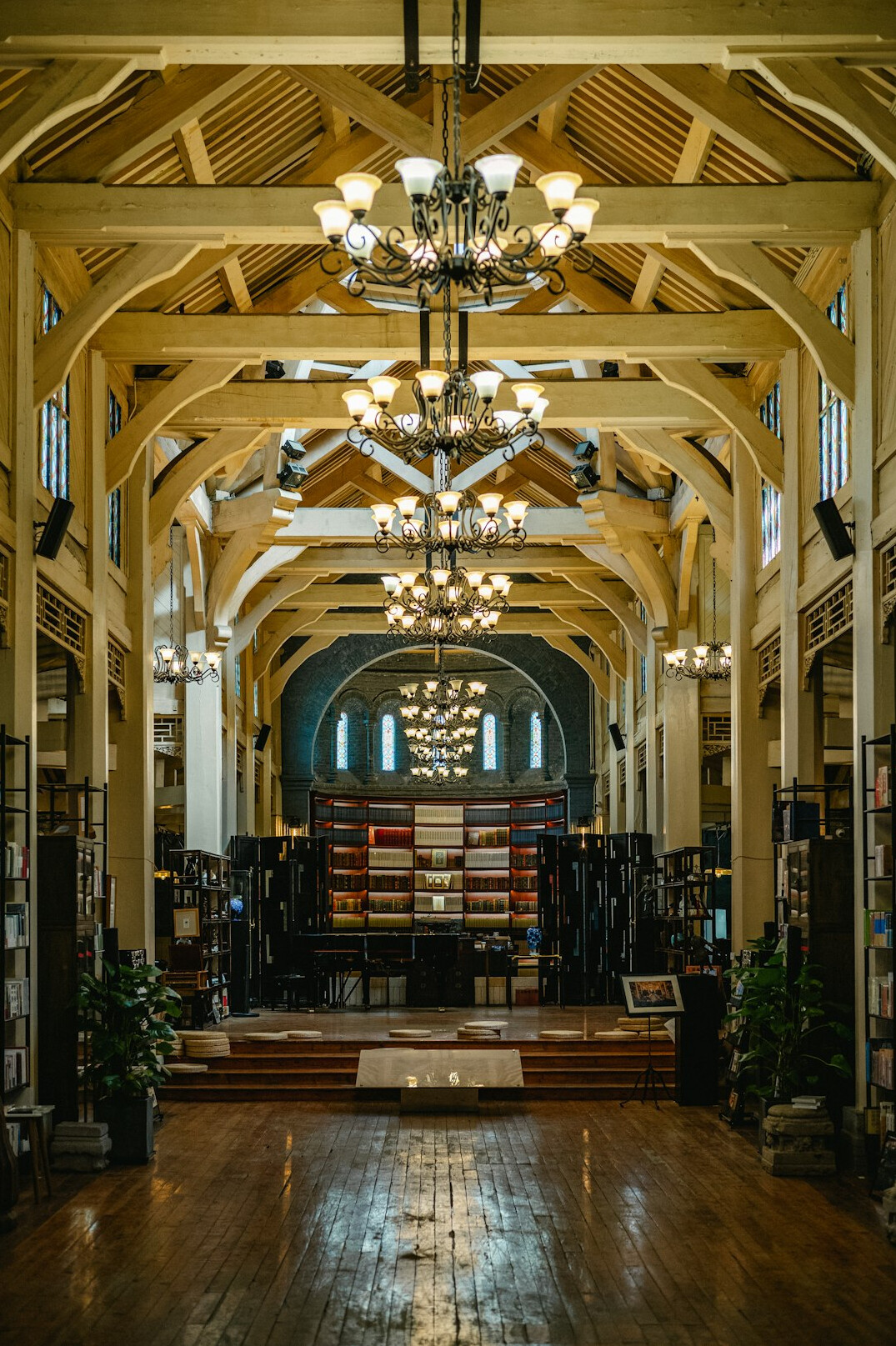 Interior of a historic library with tall wooden bookshelves and soft natural light
