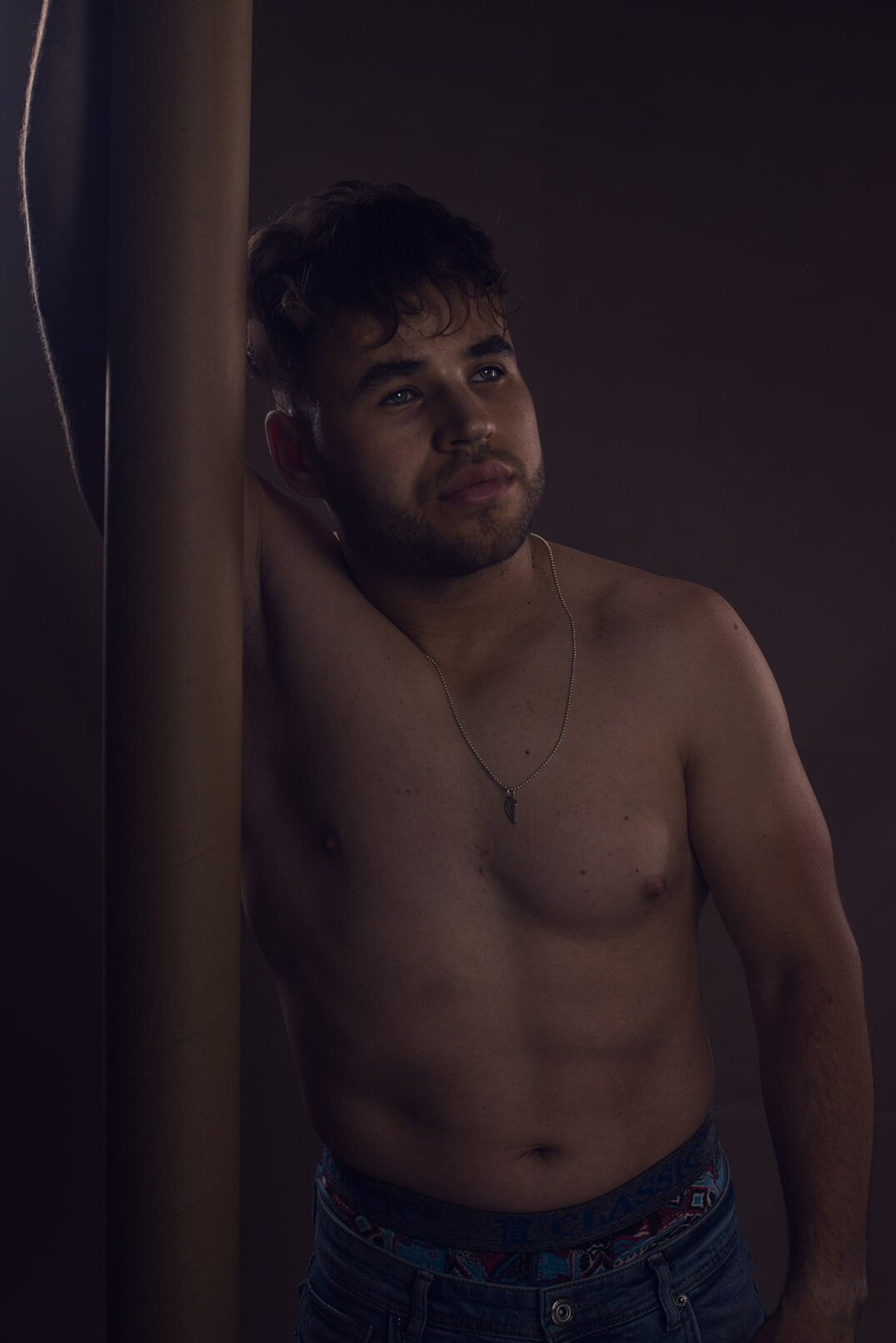 Studio portrait of a mestizo Uruguayan man in his 20s, digital content coordinator, neutral background